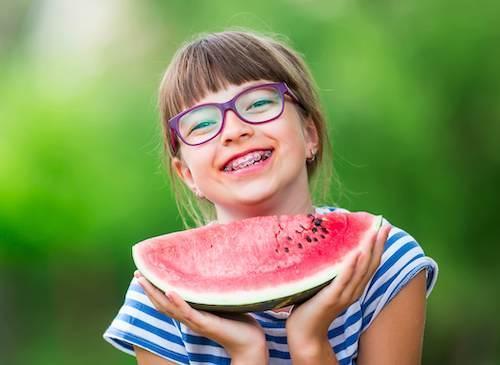 girl eating watermelon with glasses in tweed heads
