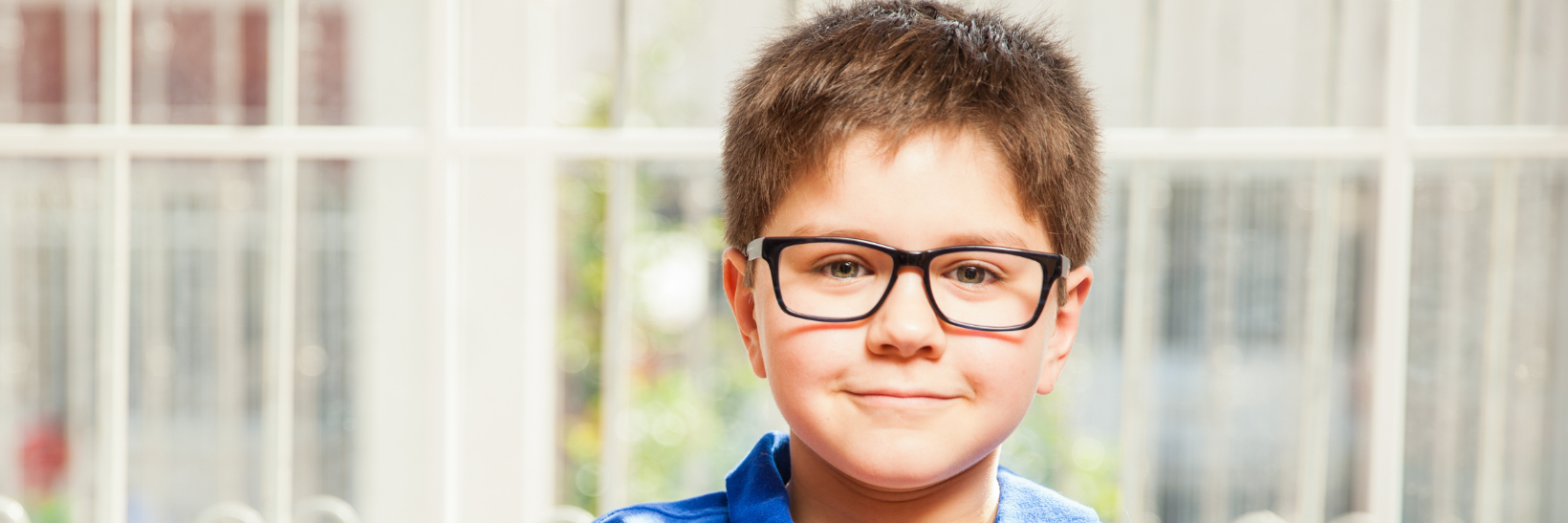 Child with glasses in tweed heads