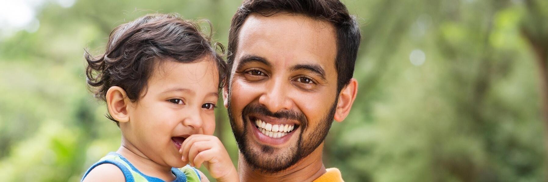 Father holding young daughter | Children's eye exams burleigh waters